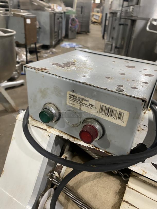 Merand Tenor 2 dough moulder, electric-powered, countertop model. Features wear and rust. Labels indicate Hubbell Wiegmann parts.