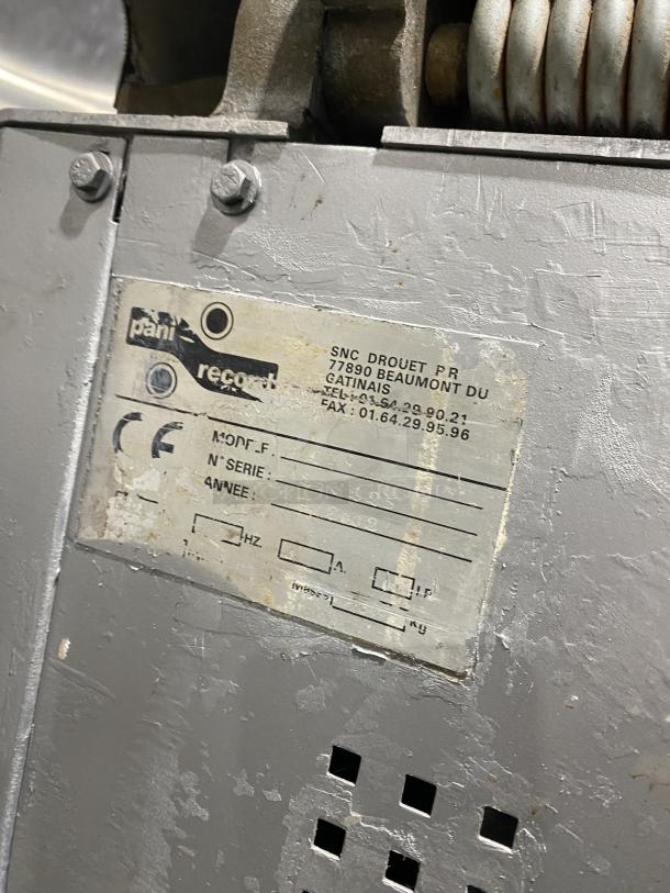 Panimatic commercial electric dough divider on casters, with visible wear. Label indicates model and manufacturer details.