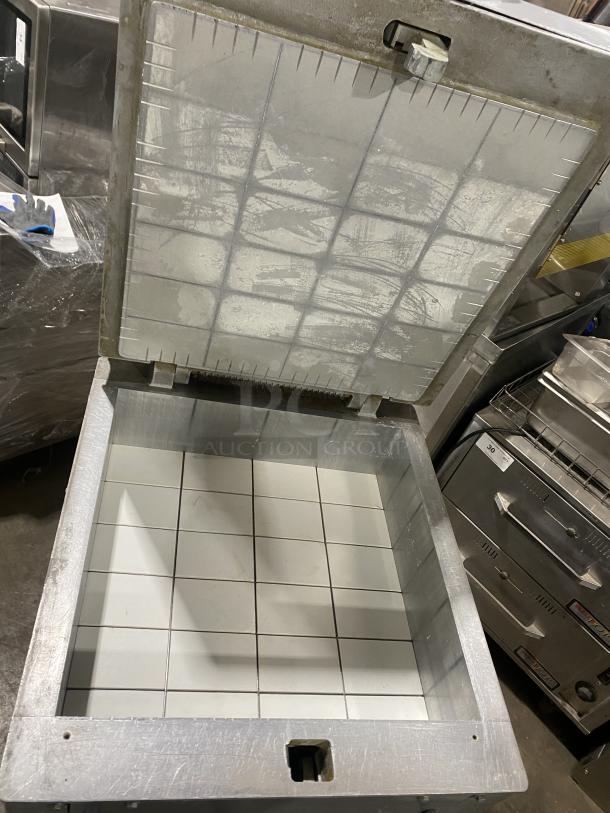 Panimatic commercial dough divider with grid interior, electric powered, free-standing, on casters for mobility.