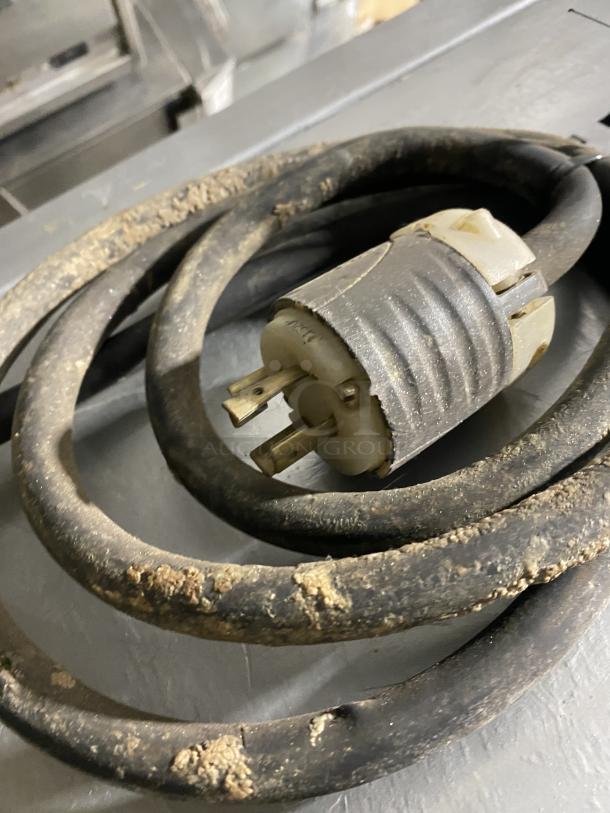 Panimatic commercial dough divider power cord, showing signs of wear and use. Electric connection for functionality.