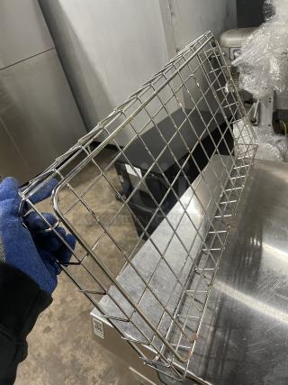 Commercial stainless steel wired bagel basket in good condition, showing sturdy metal grid design for bakery display.