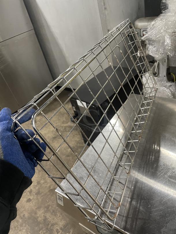 Stainless steel wired bagel basket, commercial-grade, grid design. Used condition, visible rust spots on the surface.