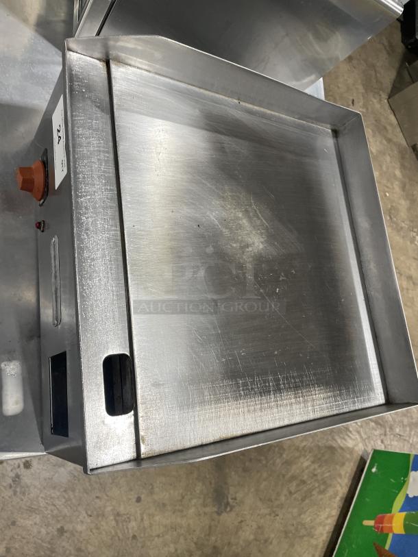 Croydon stainless steel electric griddle, model OR4E-100001W5. Features back and side splash. Heavy-duty, good condition.