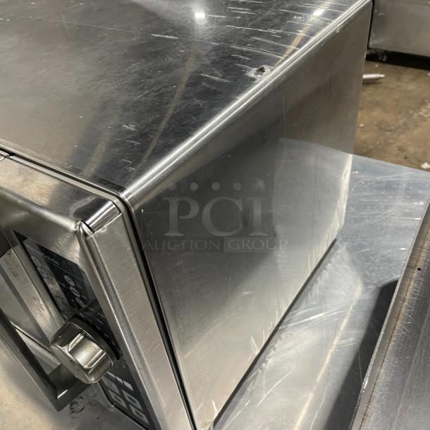 Amana RCS10DSE commercial stainless steel electric countertop microwave, 2023 model. Some surface scratches visible.