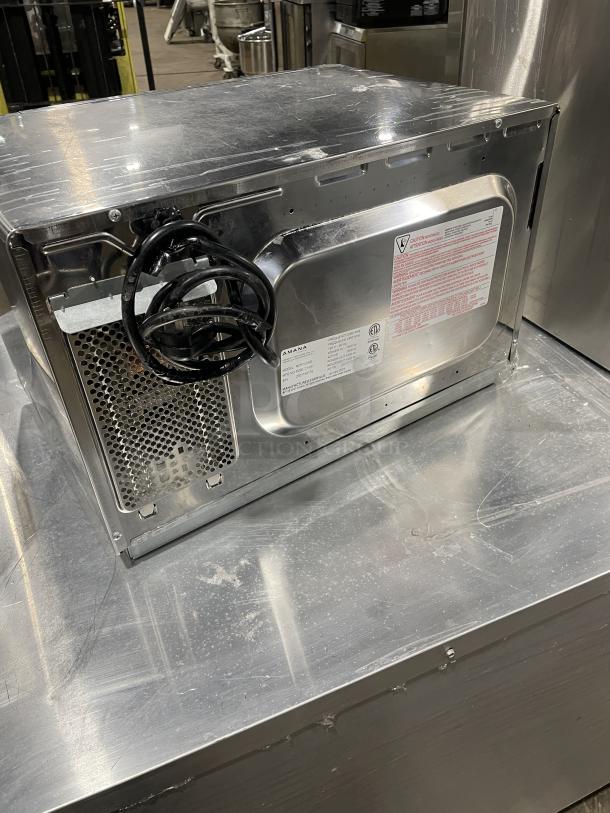 Amana 2023 commercial stainless steel microwave oven, Model RCS10DSE, electric, 120V, with visible power cord and label.