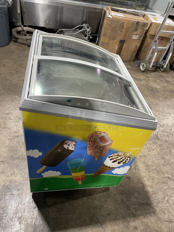 Caravell commercial ice cream merchandiser freezer, model 206-995, with top sliding glass lid, colorful exterior design.