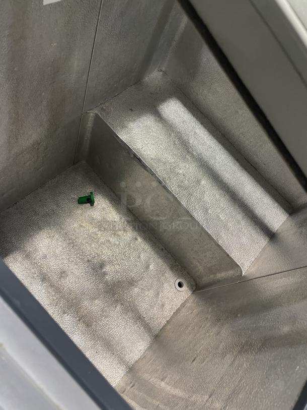 Caravell 206-995 commercial stainless steel ice cream merchandiser interior with sliding glass lid; model details visible.