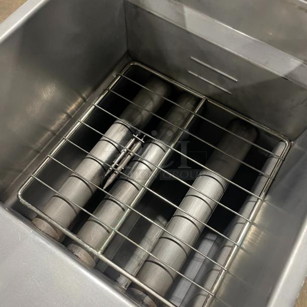 Asber stainless steel natural gas deep fryer with basket hanger, fry basket, backsplash, and casters.