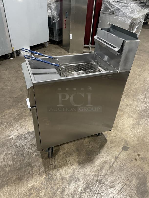 Asber stainless steel gas fryer with back splash, basket hanger, fry basket, and casters, in commercial condition.