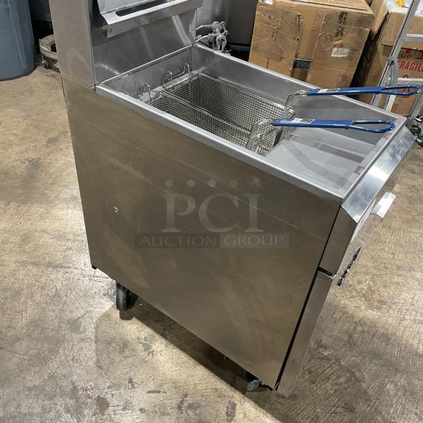 Asber stainless steel natural gas deep fat fryer with back splash, basket hanger, fry basket, and casters.