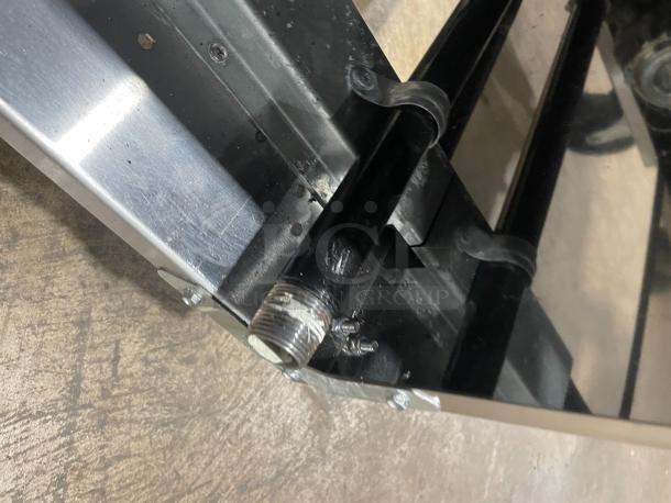 Stainless steel component of Asber commercial deep fat fryer, with visible gas connector and sturdy construction on casters.