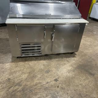 Commercial stainless steel 2-door refrigerated bain marie salad/sandwich prep table with cutting board, wired rack, and casters.