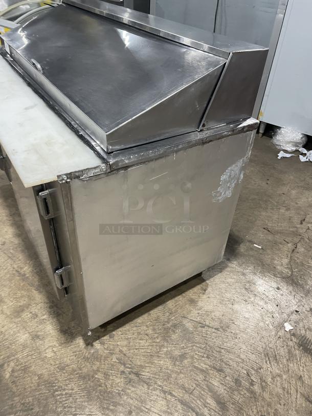 Commercial stainless steel 2-door refrigerated bain marie prep table with cutting board and poly-coated wire rack on casters.