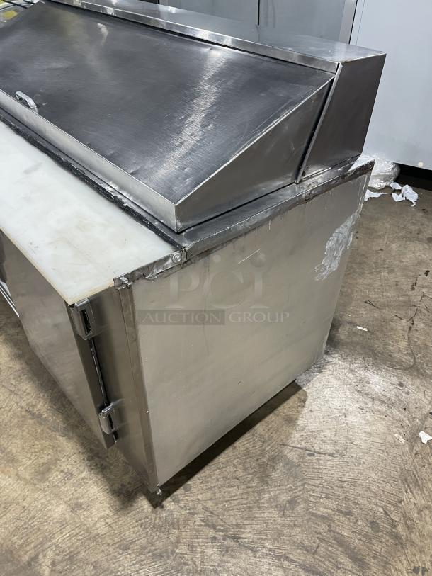 Commercial stainless steel 2-door refrigerated bain marie prep table with cutting board, poly-coated rack, on casters, used.