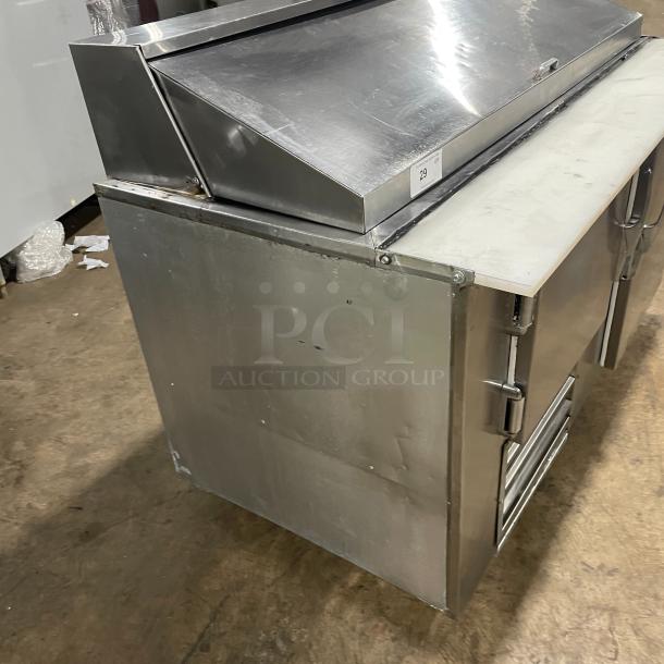 Commercial stainless steel 2-door refrigerated prep table with cutting board, poly coated wire rack, and casters.