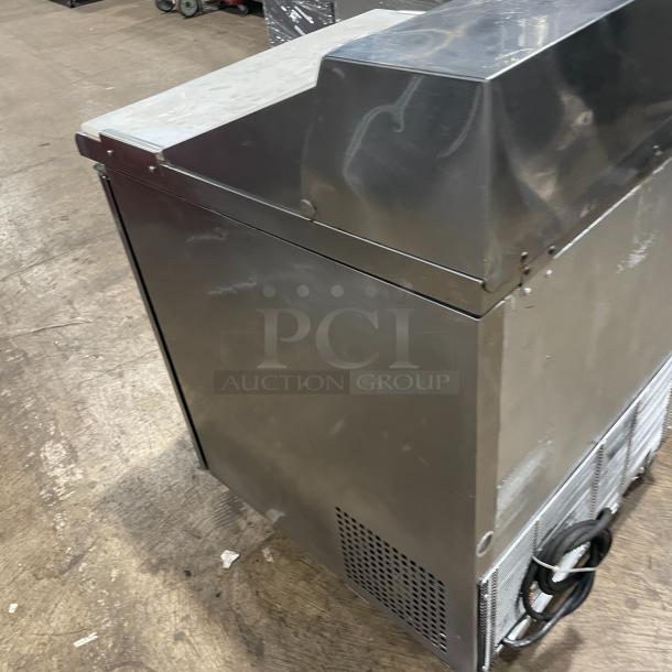 Turbo Air TST-28SD stainless steel refrigerated prep table with cutting board, single door, on casters, 115V.