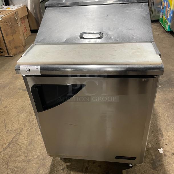 Turbo Air TST-28SD stainless steel single door refrigerated salad/sandwich prep table with cutting board, on casters.