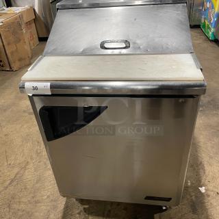 Turbo Air TST-28SD stainless steel single door refrigerated salad/sandwich prep table with cutting board, on casters.