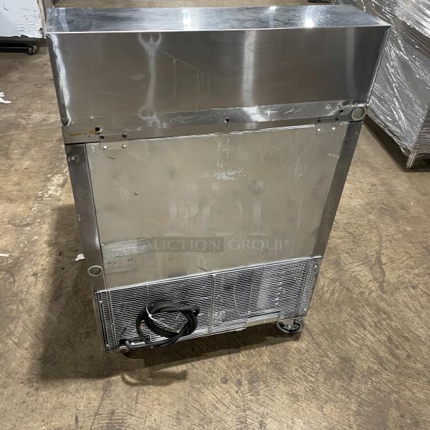 Turbo Air TST-28SD stainless steel refrigerated prep table with cutting board and casters; 115V power, visible wear.