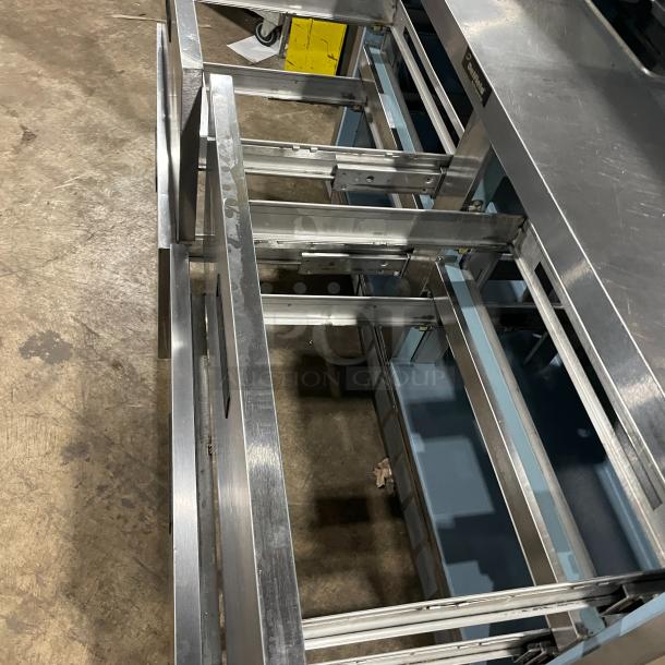 Delfield stainless steel refrigerated prep table, model UCD4464N12DD5, with 4 drawers and overhead shelf.