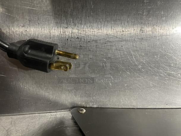 Delfield Stainless Steel Refrigerated Prep Table, Model UCD4464N-12-DD5, showing power cord and metal surface detail.