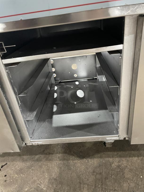 Pitco Frialator Series stainless steel 2-bay deep fryer with center enclosed cabinet, backsplash, fry basket, on casters.