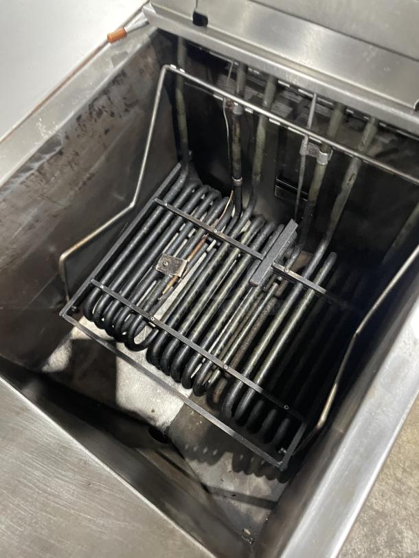 Pitco Frialator Series stainless steel 2-bay deep fat fryer system, featuring a center enclosed pan, backsplash, and basket hanger.