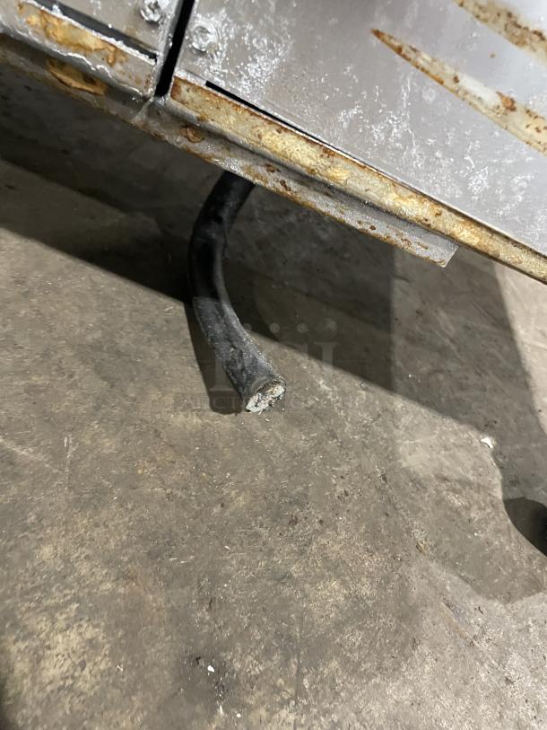 Rusted base of Pitco Frialator 2-bay fryer system showing exposed wire, indicating wear and need for repair.