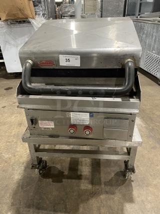 Lang stainless steel natural gas infrared clamshell griddle, model 224TH-NATMG, on equipment stand with casters.