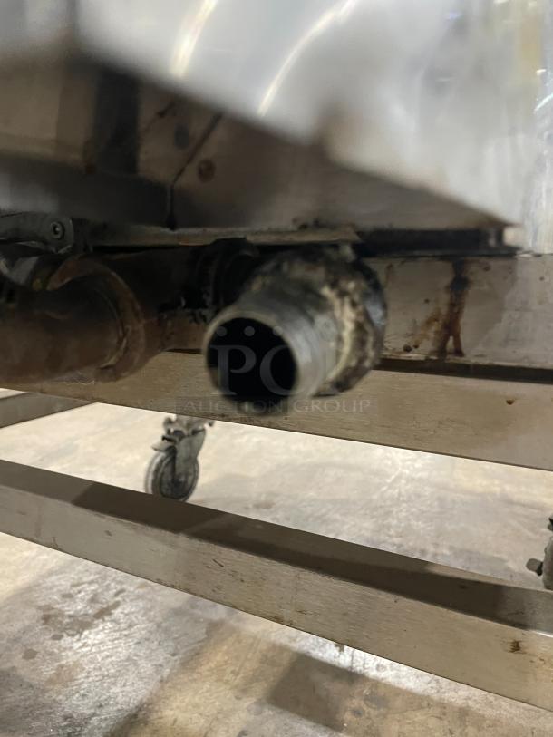 Lang stainless steel infrared clamshell griddle, model 224THNATMG, on equipment cart with casters. Natural gas powered.