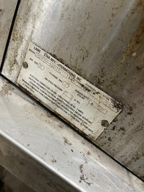 Lang 224THNATMG stainless steel gas clamshell griddle with stand. Visible wear, model and specs on label. On casters.