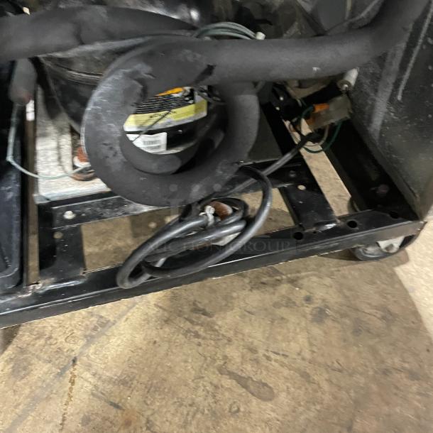 True T-23F commercial stainless steel solid door reach-in freezer, SN: 7887234, on casters, 115V 1 phase, underside view.