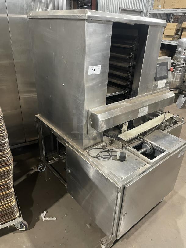 Aksar heavy-duty commercial tray wrapping machine, floor style. Stainless steel, multiple trays, good condition, electric plug visible.