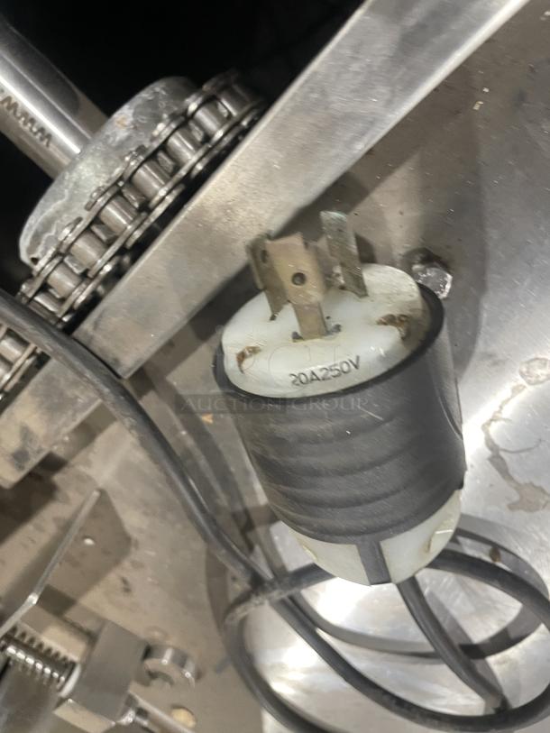 Aksar floor-style heavy-duty commercial tray wrapping machine, 20A 250V plug visible, sturdy chain mechanism.