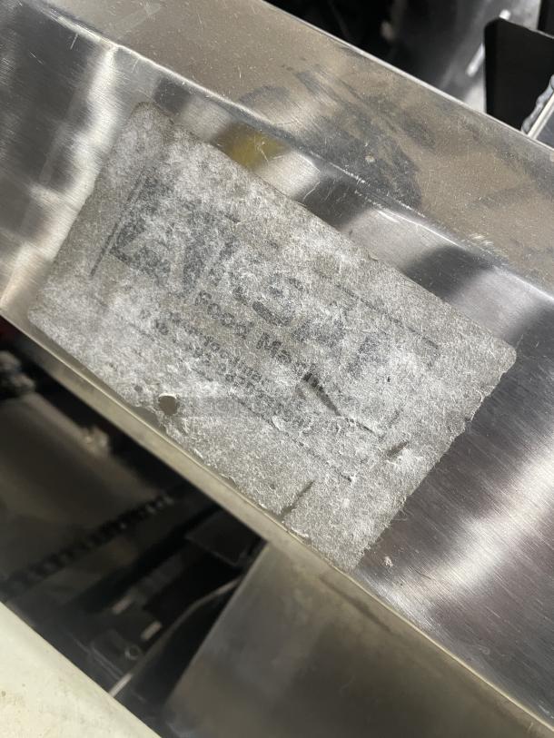 Aksar heavy-duty commercial tray wrapping machine, floor style, used condition. Faded brand label visible on metal surface.