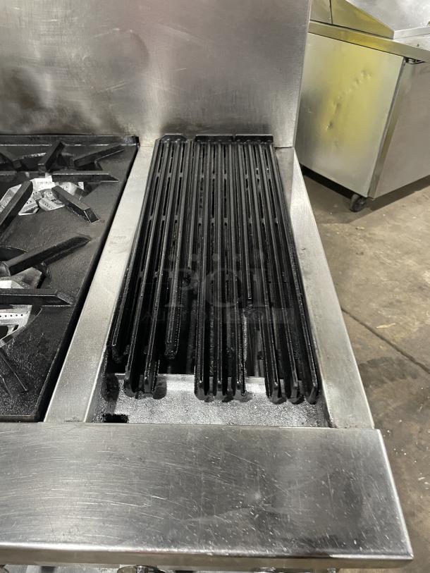 Jade Range gas-powered 4-burner and char broiler combo with full-size oven, on commercial casters. Visible stainless steel finish.