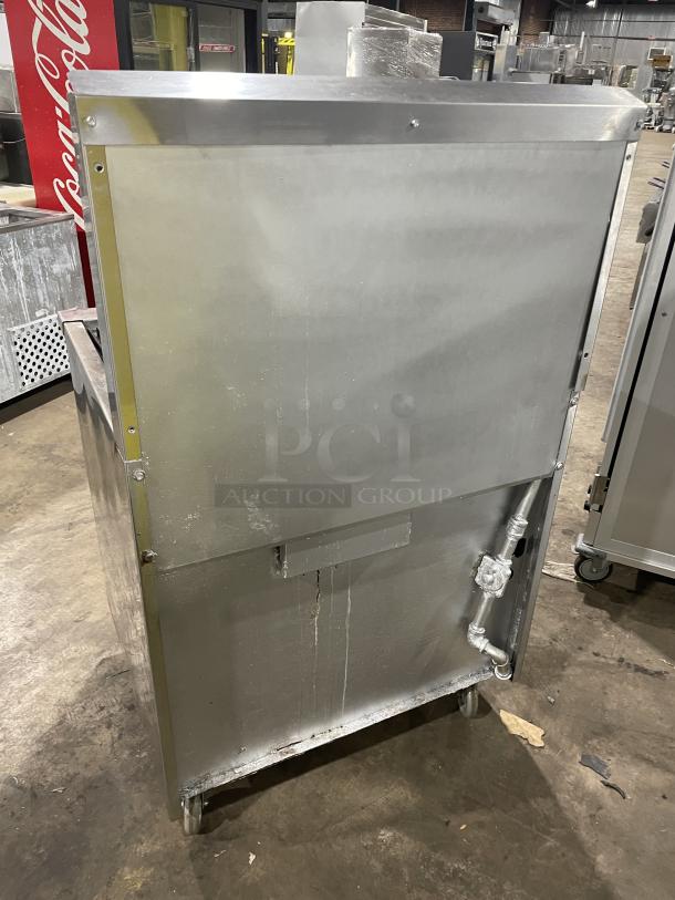 Jade Range gas-powered 4 burner char broiler combo with full oven, raised back splash, and casters. Used condition.