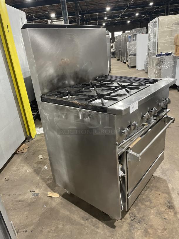 Jade Range gas-powered 4 burner/char broiler combo with full-sized oven, raised back splash, and casters; used condition.