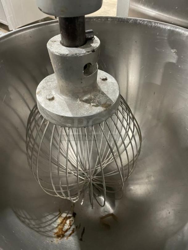 Univex SRM60+ Commercial 60 Qt Electric Mixer with stainless steel bowl and wire whisk attachment, on legs, 208-240V, working.