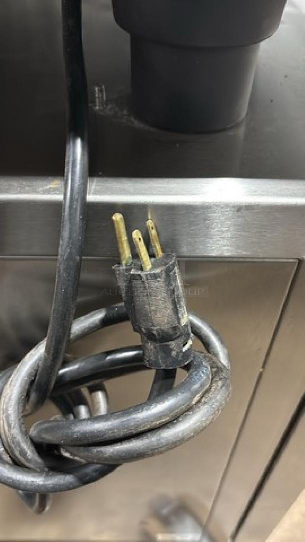 Rational SW62G natural gas combi convection oven on cart with built-in pan rack and casters. 208V, 1-phase plug visible.