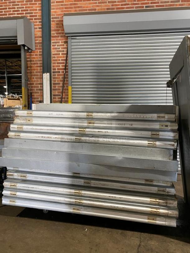 Mr. Winter 10' x 10' walk-in cooler panels stacked, includes compressor and blower, professionally removed, good condition.