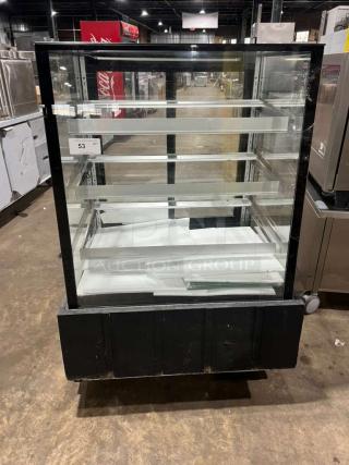 Marchia MBST36 refrigerated bakery display case, 3-tier, 115V, in good condition, clear glass, black frame, internal shelving visible.