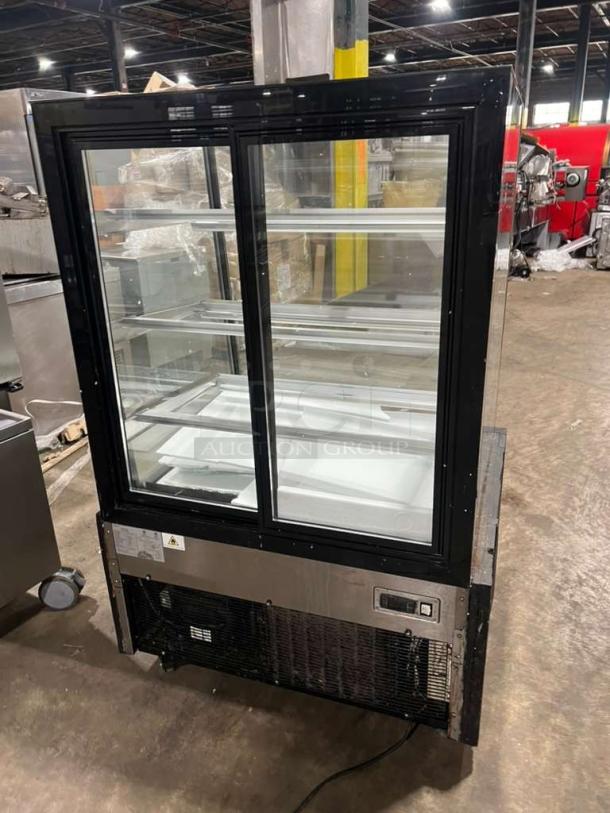 Marchia MBST36 3-tier refrigerated bakery display case, black frame, glass shelves, 115V, commercial use. Good condition.
