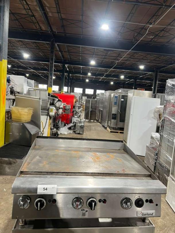 Garland GTGG36 commercial gas griddle with thermostatic controls, on legs. Heavy-duty, suitable for commercial use.