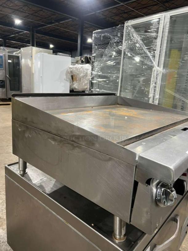 Garland GTGG36 heavy-duty commercial gas griddle with thermostatic controls and legs. Shiny surface, solid condition.