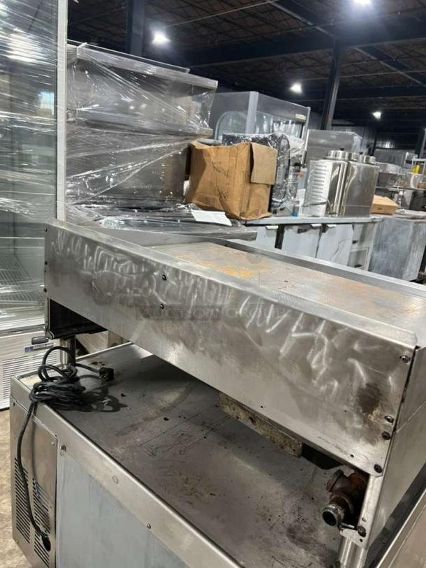 Garland GTGG36 commercial gas griddle with thermostatic controls. Heavy-duty, on legs, shows signs of use, serial 1709100101226.