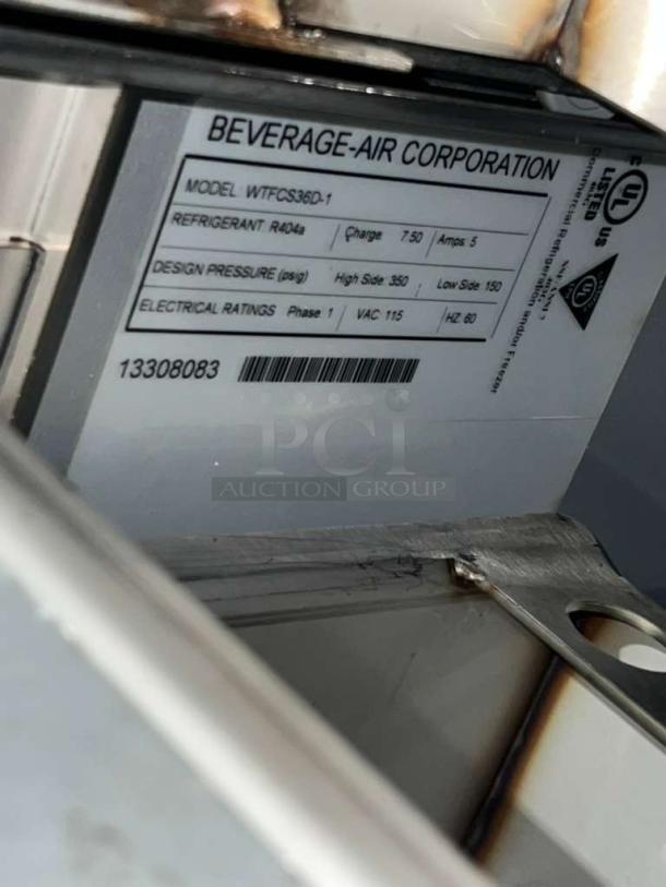 Beverage Air WTFCS36D-1 freezer label showing refrigerant details, design pressure, and electrical ratings. Serial 13308083.