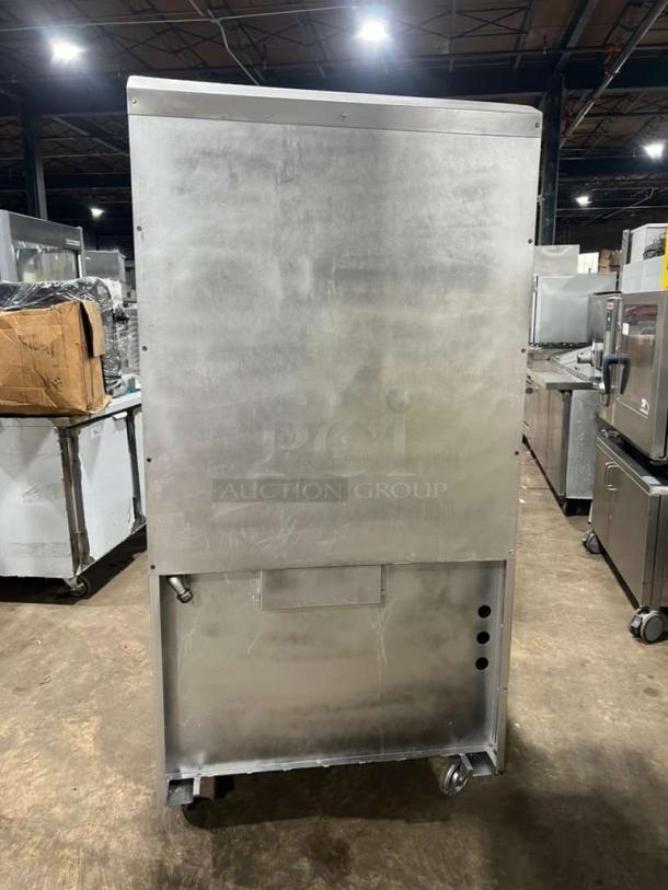 Jade Range heavy-duty commercial 4-burner gas range with full-size oven and raised double shelf backsplash on casters.