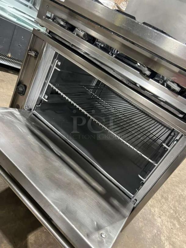 Jade Range heavy-duty 4-burner gas range with full-size oven, double-shelf backsplash, and casters. Ideal for commercial use.