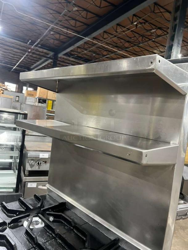 Jade Range 4-burner commercial gas range with full-size oven, raised double shelf backsplash, on casters. Good condition.